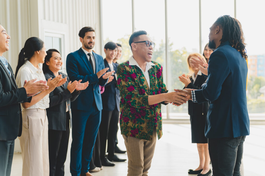 A man receiving recognition at work for a job well done